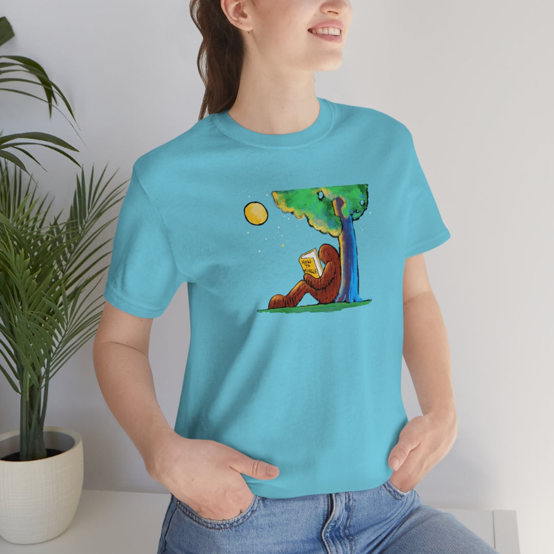 Bigfoot Reading How to Mingle Unisex Soft Cotton T-Shirt